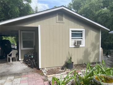 Small house with carport and landscaping at 1874 Douglas Ave, Clearwater, FL 33755