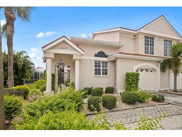 Attractive two-story home with landscaped yard and driveway at 1217 Gorda Cay Ln, Punta Gorda, FL 33950