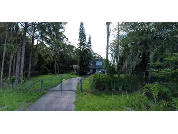 Two-story house with gated entrance at 15324 Balm Wimauma Rd, Wimauma, FL 33598