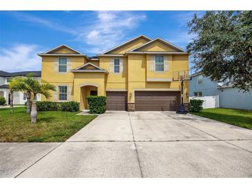 Two-story house with double garage at 10820 Carloway Hills Drive, Wimauma, FL 33598