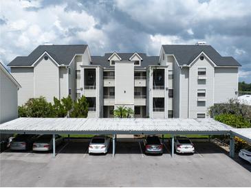 Three-story building with covered parking at 3127 W Sligh Ave # 104B, Tampa, FL 33614