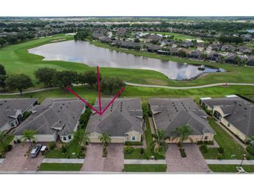 Aerial view of home in golf course community with lake views at 806 Chipper Dr, Sun City Center, FL 33573