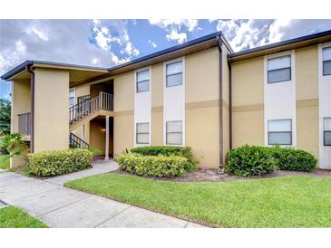 Tan building exterior with landscaping and a staircase at 10100 Sailwinds N Blvd # 205, Largo, FL 33773