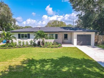 Newly renovated home with a landscaped lawn and modern finishes at 1227 Arden Ave, Clearwater, FL 33755
