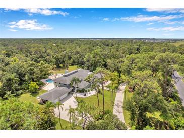 Aerial view of house with pool and large lot at 6775 Timberland Ln, Sarasota, FL 34241