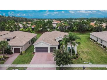 Single-Gathering home with two-car garage and lush landscaping at 16005 Cape Coral Dr, Wimauma, FL 33598