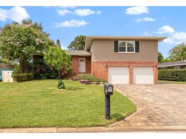 Brick home with two-car garage and nicely landscaped yard at 8212 Forest Cir, Seminole, FL 33776