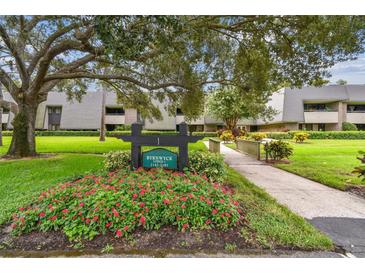 Building exterior with landscaping and walkway at 36750 Us Highway 19 N # 05102, Palm Harbor, FL 34684