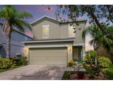 Two-story house with a landscaped yard and attached garage at 1307 Pasadena Bloom Ln, Ruskin, FL 33570