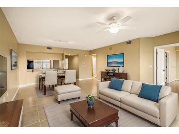 Living room with light beige walls, tiled floors and staged furniture at 1200 Country Club Dr # 1503, Largo, FL 33771