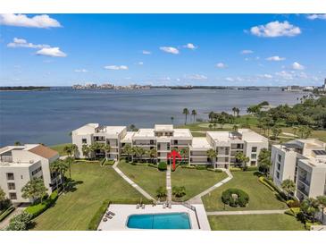 Condo building with waterfront view and community pool at 50 Coe Rd # 224, Belleair, FL 33756