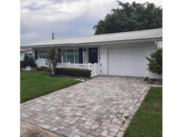 House exterior featuring a brick driveway and white front door at 10011 40Th N St # 3, Pinellas Park, FL 33782