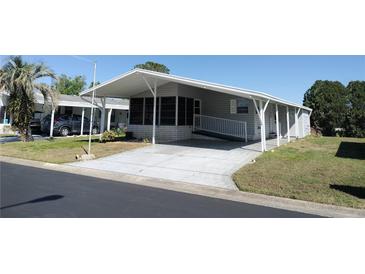 Well-maintained single-story home with a covered carport and a convenient ramp at 34045 Brown Bayou, Wesley Chapel, FL 33543
