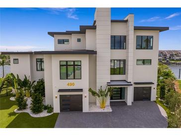 A modern, waterfront home with a three-car garage at 490 Laguna Dr, Tierra Verde, FL 33715