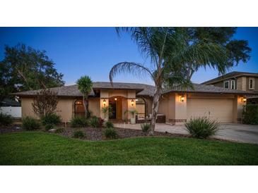 Charming one-story home with a manicured lawn and a welcoming brick-paved entrance and two-car garage at 1105 Deer Run Pl, Valrico, FL 33594