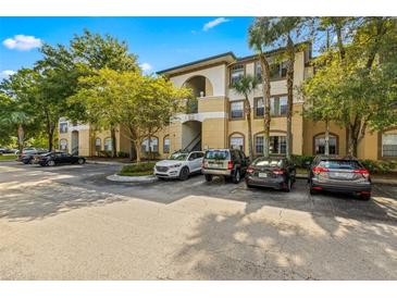 Condo building exterior with parking and landscaping at 17104 Carrington Park Dr # 520, Tampa, FL 33647