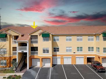 Condo building exterior with parking and surrounding landscape at 10764 70Th Ave # 3303, Seminole, FL 33772