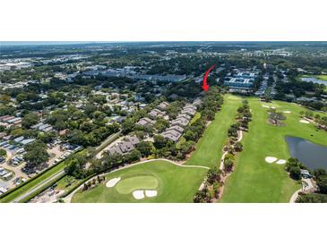 Beautiful community aerial view shows golf course, nearby homes, and mature landscaping at 9 Pelican Pl, Belleair, FL 33756