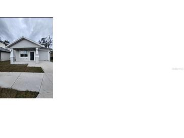 Charming single-story home with well-maintained landscaping and attached one car garage at 2404 1/2 E Chelsea, Tampa, FL 33610