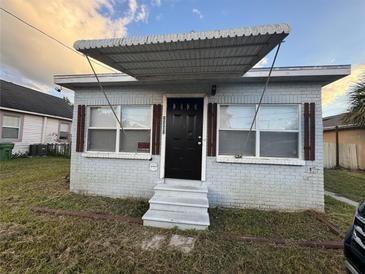 Brick home with a covered entryway and small front yard at 2201 E Ida St, Tampa, FL 33610