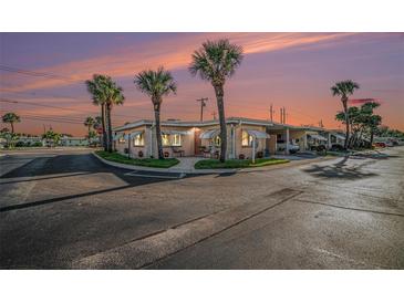 Corner house with palm trees and sunset at 250 Rosery Nw Rd # 351, Largo, FL 33770