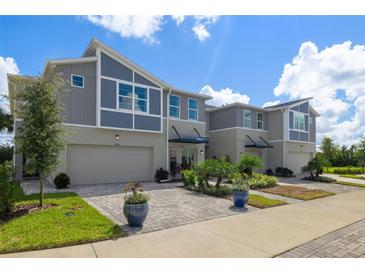 Modern townhouses with attached garages and landscaped yards at 31564 Woodland Race Loop, Wesley Chapel, FL 33545