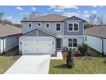 Charming two-story home with an attached two-car garage and well-maintained landscaping in a suburban neighborhood at 4285 Big Sky Dr, Spring Hill, FL 34604