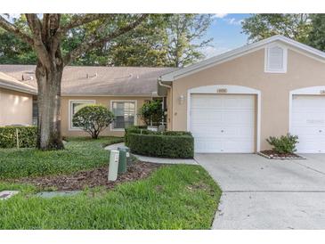 Two-car garage and manicured landscaping at 4474 Connery Ct, Palm Harbor, FL 34685