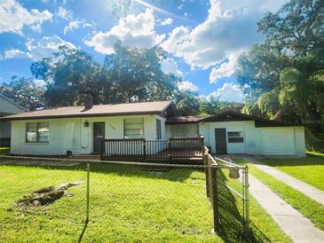 House with a deck and fenced yard at 7006 N 18Th St, Tampa, FL 33610