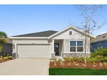 Charming one-story home featuring a two-car garage and beautifully landscaped front yard at 11814 Richmond Trl, Parrish, FL 34219