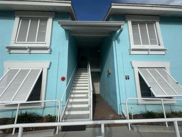 Bright blue building exterior with white stairs and railings at 3730 42Nd S Way # H, St Petersburg, FL 33711