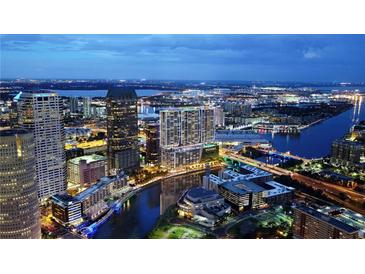Aerial view of Tampa, FL, at night, showing the city skyline and waterfront at 111 S Ashley Dr # 1907, Tampa, FL 33602