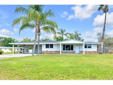 Charming single story home featuring a covered carport and well maintained lawn at 233 W College Ave, Ruskin, FL 33570