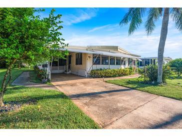 Single-story home with carport and landscaped yard at 271 Lake Tarpon Dr # 16, Palm Harbor, FL 34684