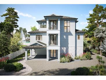 Two story home with gray siding and a charming front porch at 625 80Th Ave, St Pete Beach, FL 33706