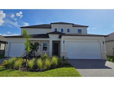 Two-story house with a three-car garage at 7045 E 113Th Ct, Palmetto, FL 34221