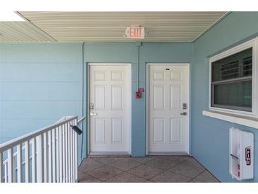 Clean hallway with white doors and fire safety equipment at 6000 2Nd E St # 6, St Pete Beach, FL 33706