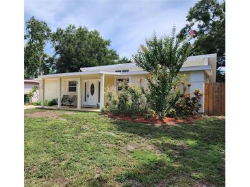 Charming single-story home with a well-maintained front yard and covered porch at 1155 7Th N St, Safety Harbor, FL 34695