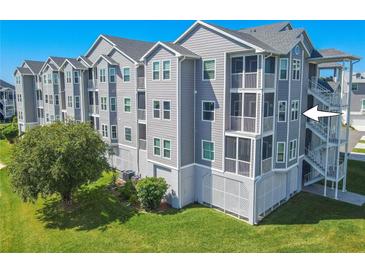Gray multi-story building with balconies and exterior stairs at 5722 Biscayne Ct # 203, New Port Richey, FL 34652