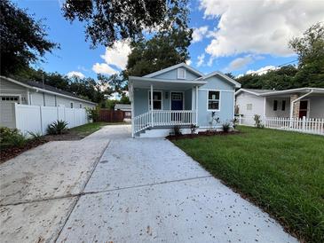 Newly renovated light blue home with a porch at 1010 E Flora St, Tampa, FL 33604