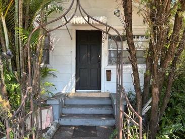 Charming home exterior with an arched entry and freshly painted front door at 2001 15Th S Ave, St Petersburg, FL 33712