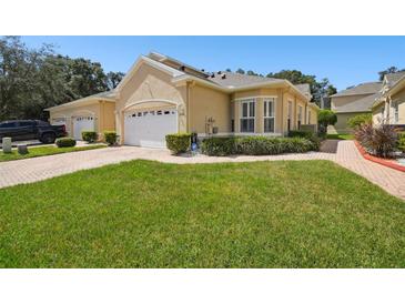 Tan house with white garage door and grassy yard at 2541 Gailwood Dr, New Port Richey, FL 34655