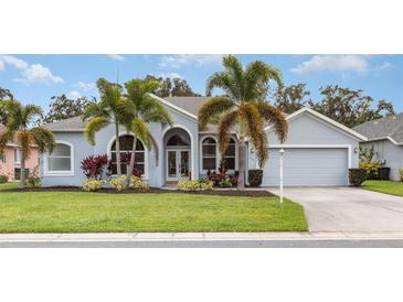 Charming one-story home with lush landscaping and palm trees at 5711 31St E Ct, Ellenton, FL 34222