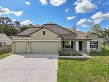 Two-story house with two-car garage and landscaping at 4013 Chadwick Ave, Spring Hill, FL 34609