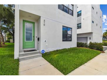 Modern home with light green front door and walkway at 310 N Oregon Ave, Tampa, FL 33606