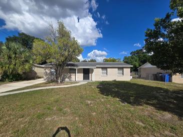 Front view of a light beige house with a yard at 3605 N 56Th St, Tampa, FL 33619