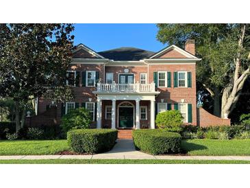 Brick home with columns and manicured hedges at 29731 Chapel Park Dr, Wesley Chapel, FL 33543