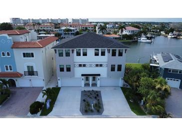 Modern three-story waterfront home with attached two-car garage at 160 174Th Terrace E Dr # A, Redington Shores, FL 33708