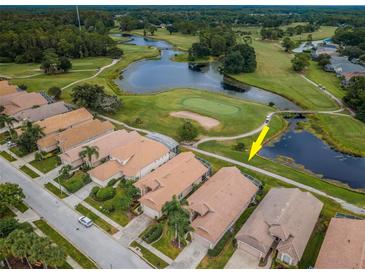 Aerial view of a house near a golf course and pond at 4350 Live Oak Blvd, Palm Harbor, FL 34685