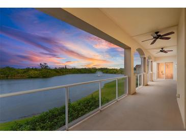 Enjoy colorful sunsets over the lake from this spacious balcony with glass railings and ceiling fans at 43 Bayview S Ct # A, St Petersburg, FL 33711